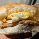 hand holding breakfast sandwich